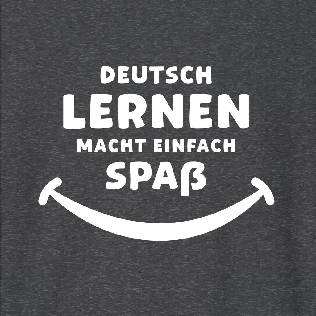 Close-up of Dark Heather German learner T-shirt featuring the “Deutsch Macht Spa” print