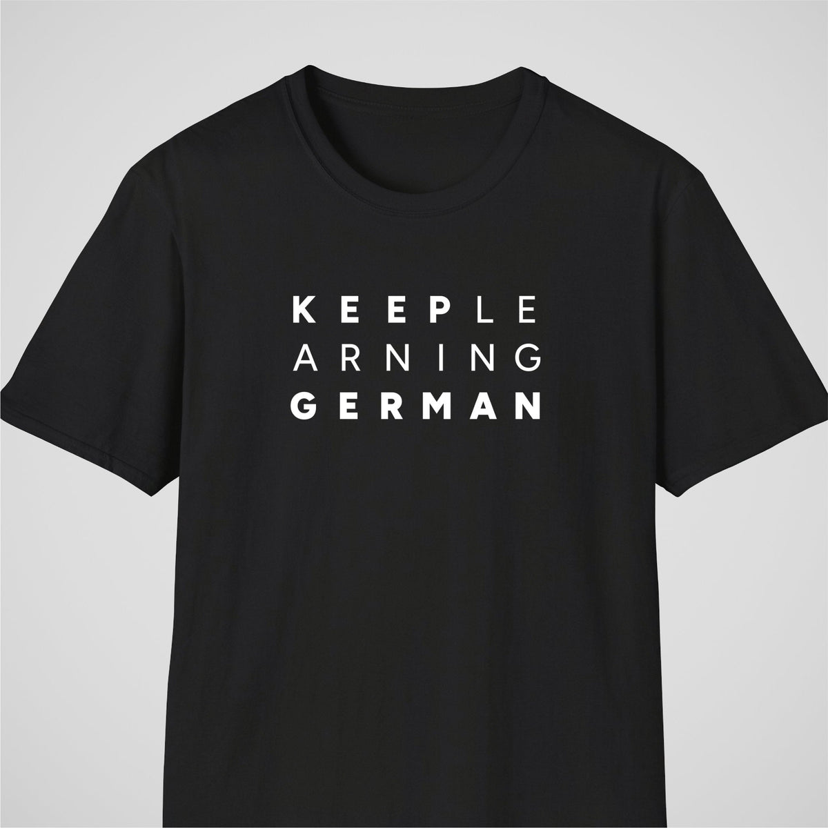 Black German learner T-shirt featuring the “Keep Learning German” design