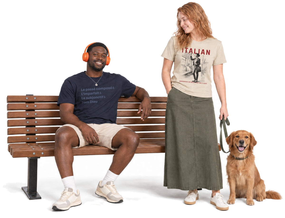 Two language lovers wearing Tees n’ Tongues T-shirts with a dog